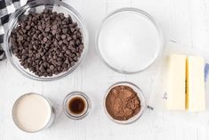 ingredients to make chocolate ice cream laid out on a white wooden table with black and white checkered towel