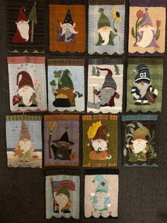 a quilted wall hanging with many gnomes on it's sides and small squares