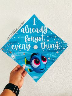 someone holding up a blue graduation cap with the words i already forgot every thing on it