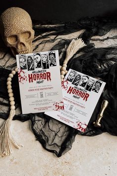 two horror themed wedding cards on top of a black lace tablecloth with a skull