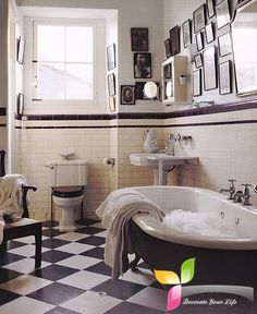 an old fashioned bathroom with black and white checkered flooring, antique bathtub