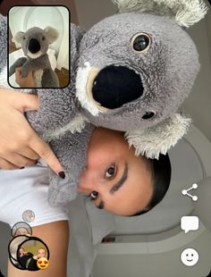 a man holding a stuffed koala bear over his head with an instagram button