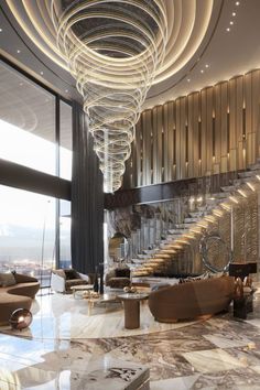 an elegant lobby with marble flooring and spiral chandelier above the staircases