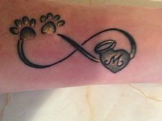 a tattoo on the arm of a person with an animal paw and heart in it