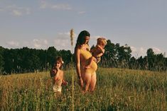 a woman and two children in a field