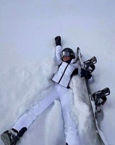 a person laying in the snow with their skis on