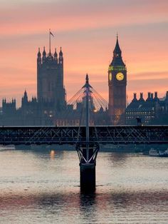 the big ben clock tower towering over the city of london, england at sunset or dawn