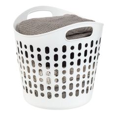 a white laundry basket with black dots on the front and grey linings, sitting against a white background