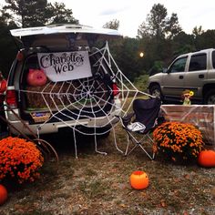 a van with pumpkins and decorations in the back