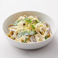 a white bowl filled with pasta and vegetables