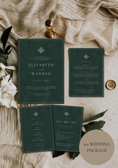 the wedding stationery is set on top of a table with flowers and greenery