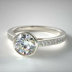 a white gold diamond engagement ring with channel set diamonds