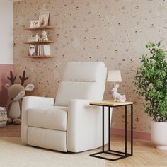 a white recliner chair sitting in front of a wall with flowers and plants on it