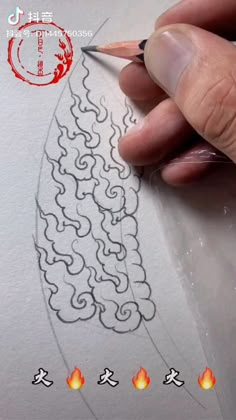 someone is drawing on paper with a pencil