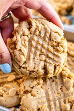 a person picking up a peanut butter cookies from a pan