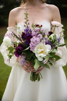 a bride holding a bouquet of flowers in her hands