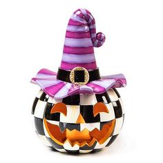 a glass pumpkin with a purple hat on it's head, sitting in front of a white background