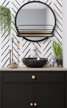 a bathroom vanity with a round mirror above it and a black bowl on the counter