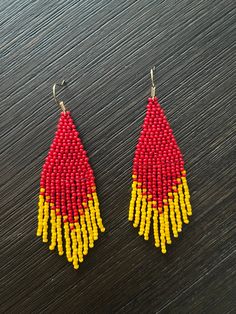 Show your support for the Kansas City Chiefs football team by wearing these red and yellow beaded fringe earrings! GO Chiefs!   Details: * Handmade * Lightweight * Toho Seed Beads * Nylon Thread * Nickel Free Ear Hook (Gold) * Length - 2.95 in * Width - 1.10 in Traditional Red Beaded Earrings With Colorful Beads, Red Beaded Earrings With Large Beads, Red Beaded Drop Earrings With Large Beads, Red Dangle Earrings With Colorful Beads, Traditional Red Beaded Earrings With Large Beads, Traditional Red Beaded Chandelier Earrings, Red Colorful Beads Dangle Earrings, Red Colorful Beaded Dangle Earrings, Red Dangle Beaded Earrings With Colorful Beads