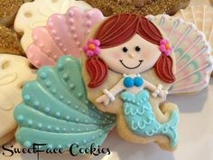 cookies decorated like mermaids and seashells on a plate