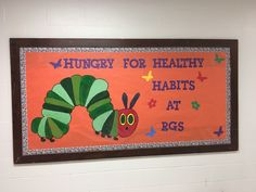 the very hungry caterpillar is hanging on the wall next to the sign that says hungry for healthy habitts at rgs