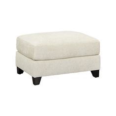 a white ottoman with black legs on a white background