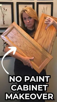 a woman holding two pieces of wood with the words no paint cabinet makeover