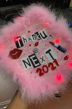 a pink light up hat with some lipstick on it and lights in the shape of letters