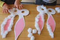 two children are playing with paper machs on the table