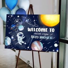 a welcome sign with balloons in the background and an image of astronauts on the moon