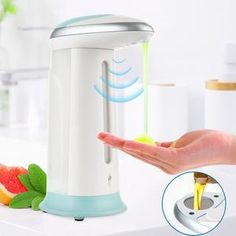 a person is pouring liquid into a water dispenser with fruit on the counter