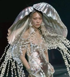 a woman in a dress made out of pearls