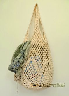 a crocheted bag hanging on a wall with the words free written below it