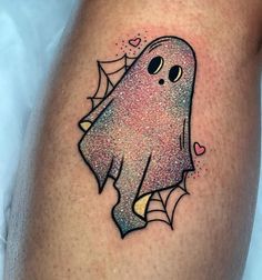 a tattoo with a ghost on the side of it's leg, and hearts in the background