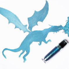 a drawing of a blue dragon next to a marker