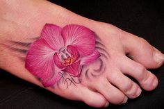 a foot with a pink flower on it