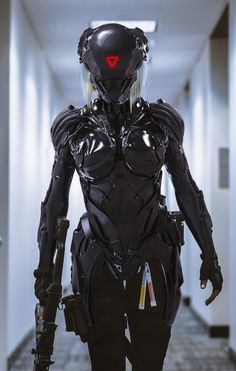 a woman in futuristic suit walking down a hallway