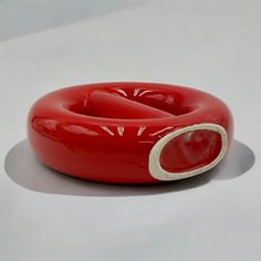 a red object sitting on top of a white table