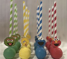 sesame street birthday candles are lined up in the shape of balls with faces on them