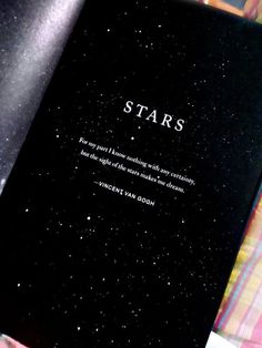 an open book with the words stars written in white on it's black cover