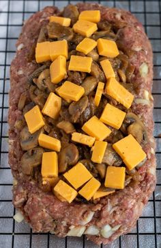 cheese and mushrooms are on top of the ground beef patties, ready to go into the oven