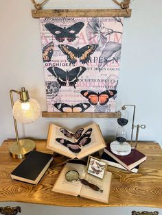 a wooden table topped with lots of books and an open book on top of it