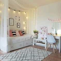 a bedroom with white walls and lights on the ceiling