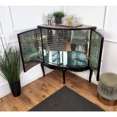 a table with a glass top and metal mesh coverings in front of a door