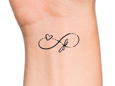 a wrist tattoo with the letter f on it's left side and an arrow in the middle