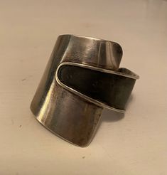 This American Modernist Ed Wiener's sterling silver mid-century cuff bracelet measures 2.25 inches wide. It is in good vintage condition. The black has a little wear and as a result I lowered the price accordingly. I polished the sterling with a cloth to give it a little shine, but it can probably be cleaned more.  It was definitely worn by someone. Vintage Cuff Bangle With Polished Finish, Modernist Polished Cuff Bangle Bracelet, Modernist Polished Cuff Bracelet, Modernist Cuff Bracelet With Polished Finish, Modernist Polished Cuff Bracelet For Formal Occasions, Modernist Bangle Cuff Bracelet For Formal Occasions, Formal Wide Band Sterling Silver Cuff Bracelet, Vintage Wide Band Bracelet For Formal Occasions, Adjustable Modernist Cuff Bracelet For Formal Occasions