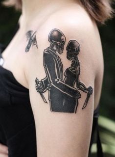 a woman with a skeleton tattoo on her shoulder