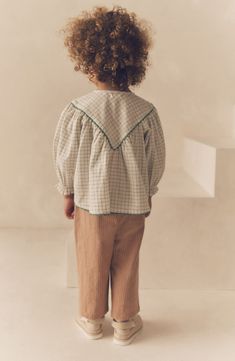 A flouncy rickrack-trimmed cotton top in a crisp windowpane check is paired with cotton-and-linen pants in this adorable outfit. Top has front button-and-loop closure Pants have smocked waist Top is 100% cotton; pants are 80% cotton, 20% linen Machine wash, tumble dry Imported Blouse And Trousers, Neutral Blouses, Outfit Top, Polo Rugby Shirt, High Waisted Cropped Jeans, Dressing Gown Robe, Striped Wide Leg Pants, Beachwear Skirt, Cover Beachwear