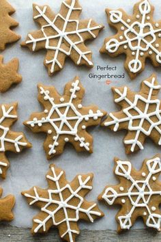 gingerbread cookies decorated with icing and snowflakes on a sheet of paper