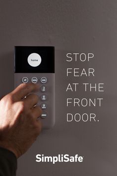 a person pressing buttons on a wall with the words stop fear at the front door